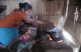 Woman cooking over a traditional stove
